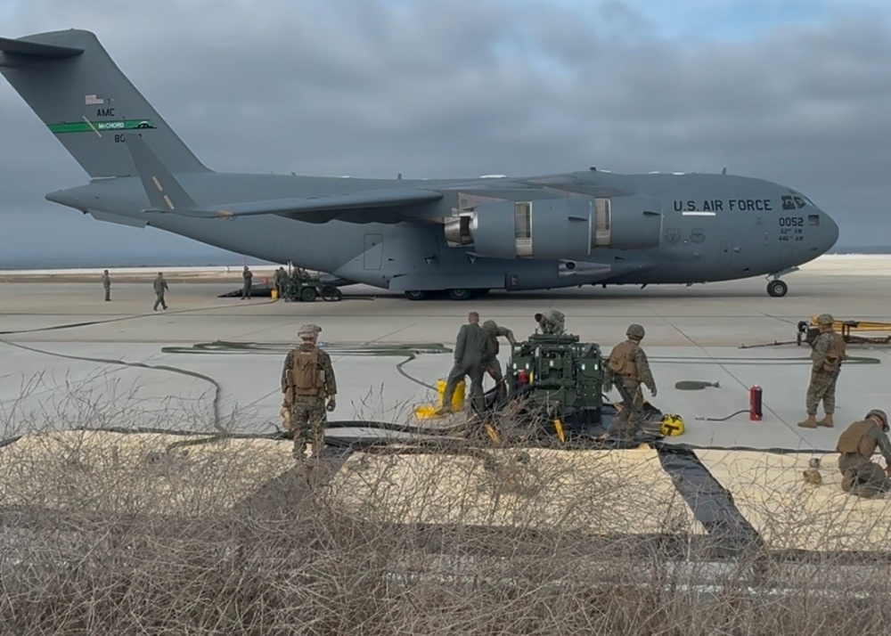 Airmen and Marines defuel a C-17 to support Marine F-35B refueling