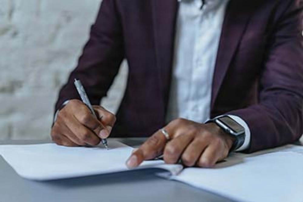 A Defense Threat Reduction Agency professional reviews and signs official documents A Defense Threat Reduction Agency professional reviews and signs official documents