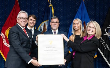 Mr.Hunter Lutinski, SES presenting at award presentation.