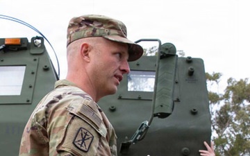 U.S Military personnel talking with foreign military personnel.