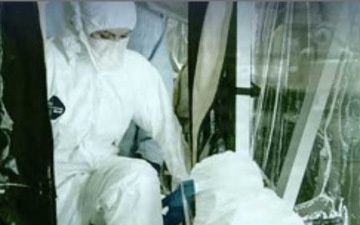 Military personnel in white mop suits