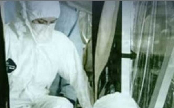 Military personnel in white mop suits