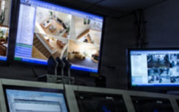 A Defense Threat Reduction Agency analyst monitors multiple computer screens as part of the Multi-Sensor Aerosol Rapid Monitoring System (MARMS) operations.