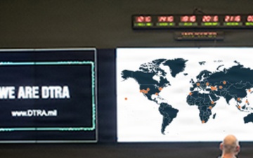Defense Threat Reduction Agency personnel monitor multiple screens in an operations center.