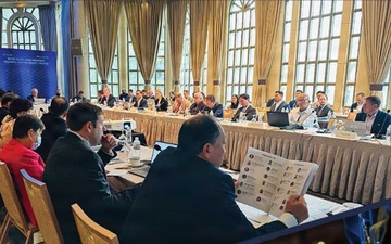 A composite image showing a meeting in progress and hands interacting with a tabletop screen illustrates Defense Threat Reduction Agency