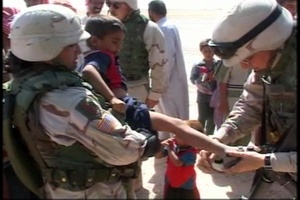 Soldiers Handing Out Clothing and Toys to Children