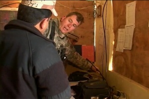 U.S. Soldier Discusses Electronics with Iraqi Soldiers