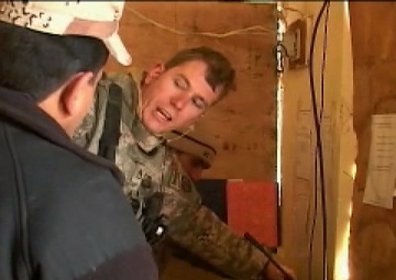 U.S. Soldier Discusses Electronics with Iraqi Soldiers