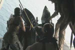 U.S. Airmen and Marines Deploy a Boat From a Helicopter