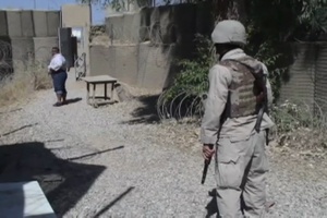 Ugandan and Iraqi Security Guards Inspect Civilians