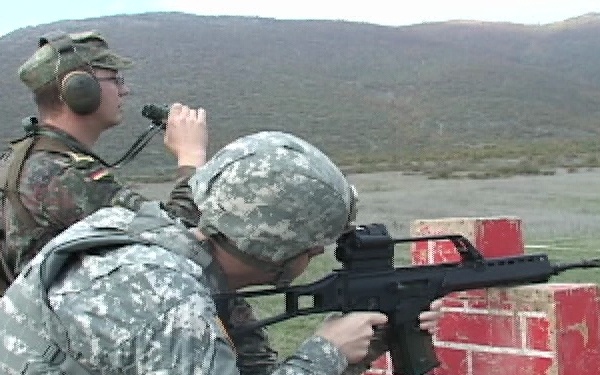 German and American Soldiers Fire Weapons at Camp Bondsteel