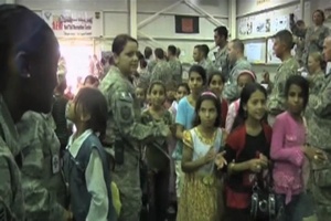 Service Members Interact with Children at an Iraqi Kids Day Event