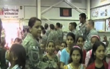 Service Members Interact with Children at an Iraqi Kids Day Event