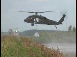 Guardsmen airdrop sandbags to reinforce levee