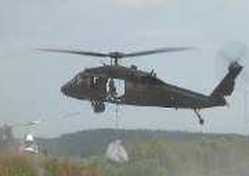 Guardsmen airdrop sandbags to reinforce levee