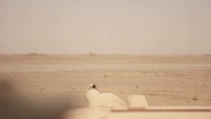 B-Roll of Tanks scanning area with main gun and rolling through Afghanistan