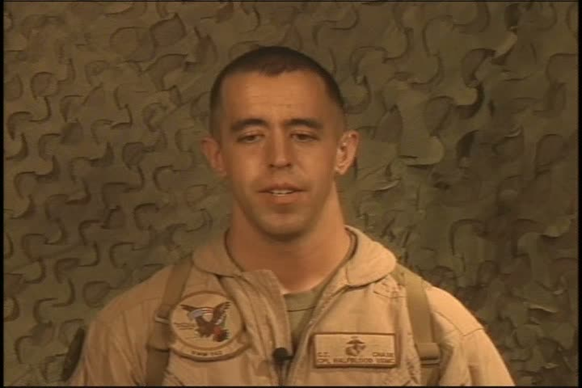 Cpl. Christopher Chase talks to an KUSA-TV reporter about his responsibilities and the anniversary of the 9/11 terrorist attacks.