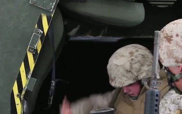 Marines go through the Humvee Egress Assistance Trainer