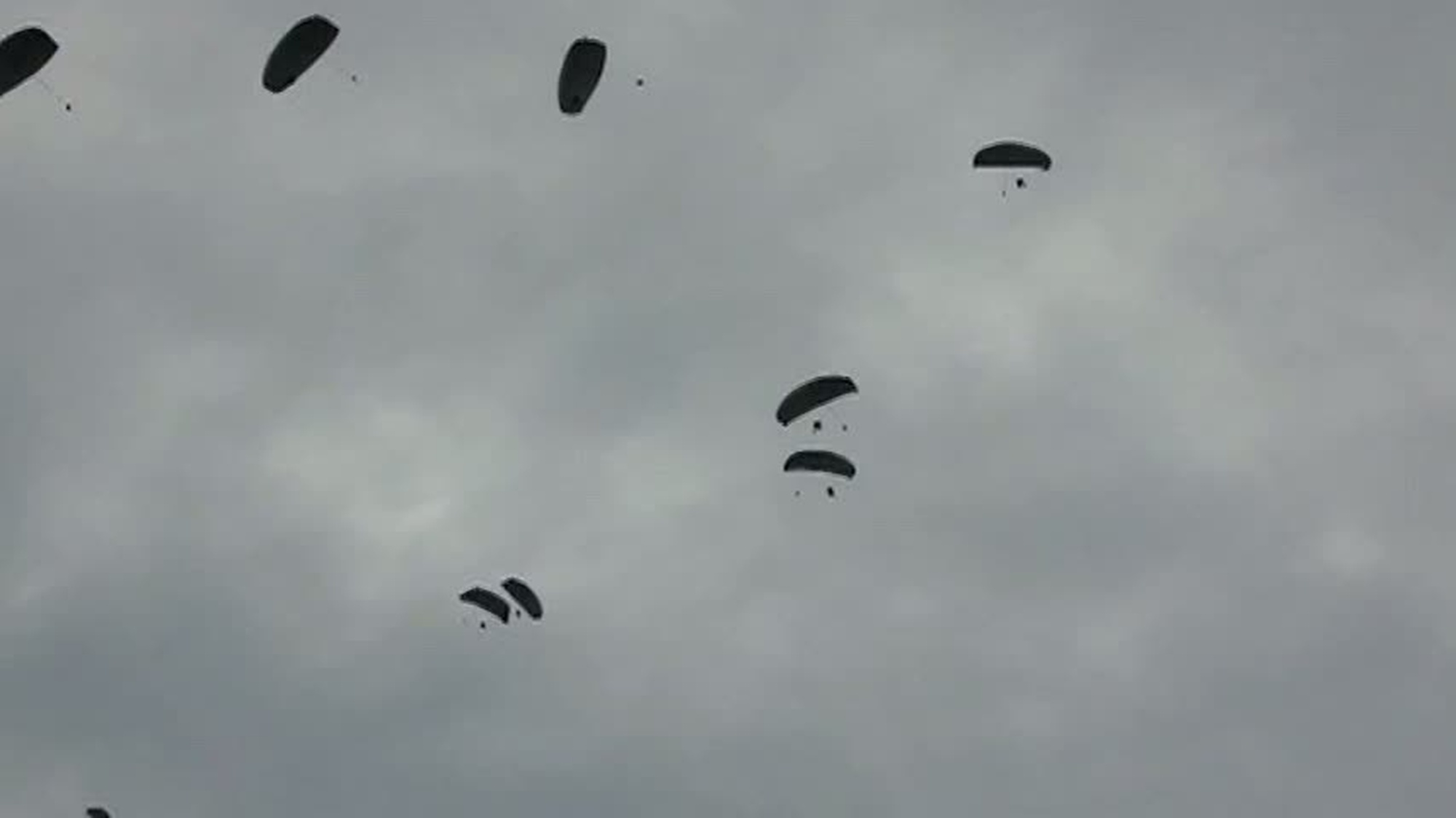U.S. paratroopers using T-11 parachutes, conduct an airborne operation from  a C-130 Hercules aircraft