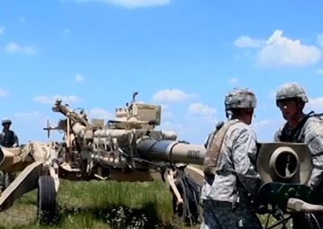 Paratroopers Unload, Fire Howitzer