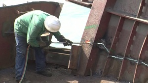 Response crews remove sections of grounded freighter