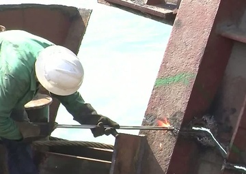 Response crews remove sections of grounded freighter