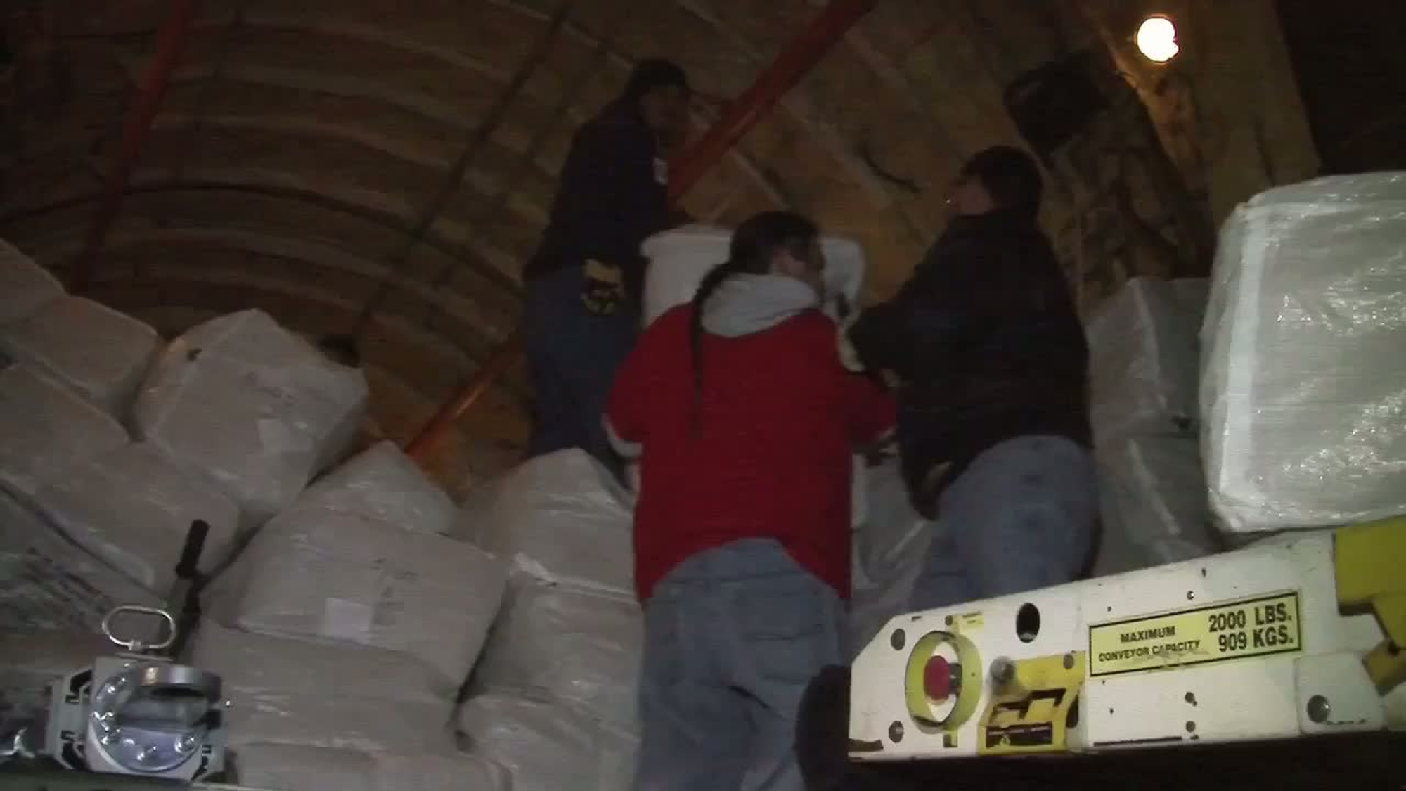 Americorp Volunteers unload two Russian planes of donated blankets to FEMA to be distributed to Hurricane Sandy survivors in the NY area.