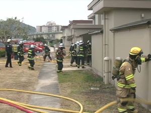 Firefighters Work Together to Perform Rescue Drill