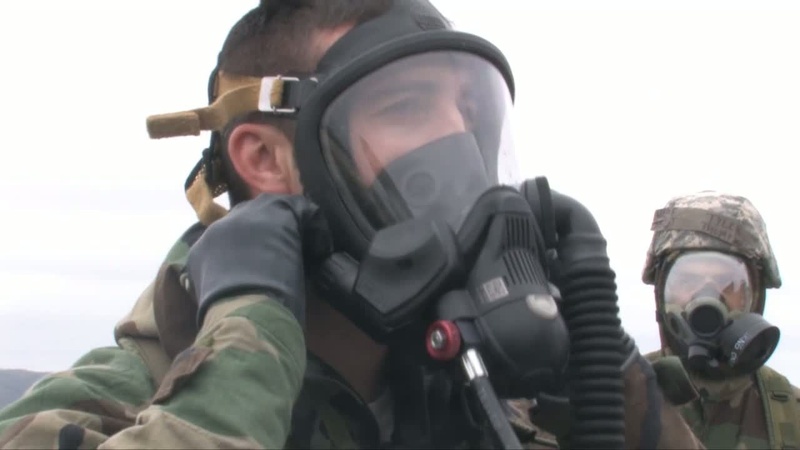 Airmen Operate Fire Truck in Gas Masks