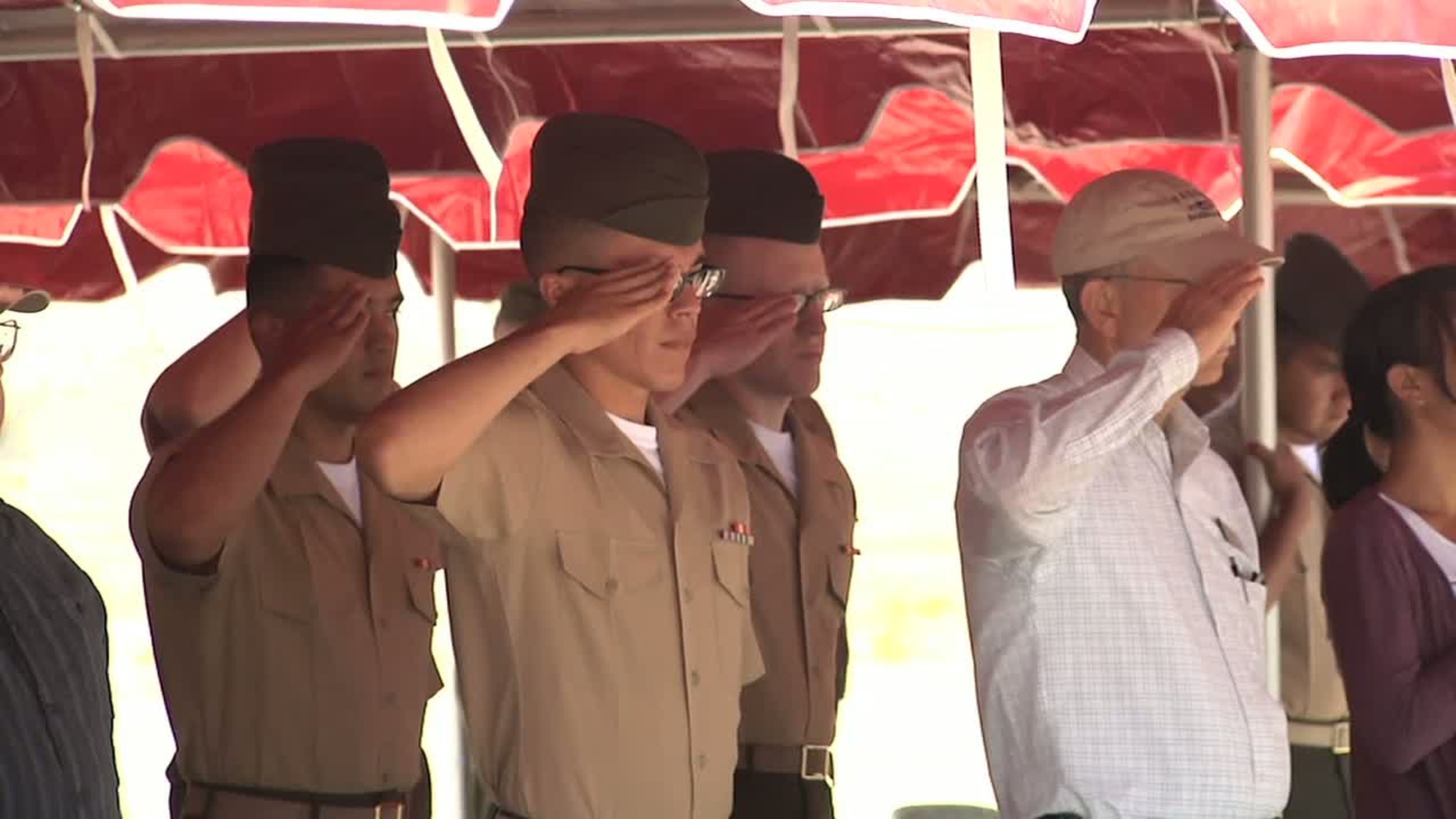 Marines serving with 5th Marine Regiment add an Afghanistan streamer to their Battalion Colors during a rededication ceremony here, June 5. Available in high definition.