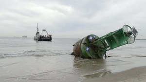 Coast Guard, Navy Pull Buoy from Beach