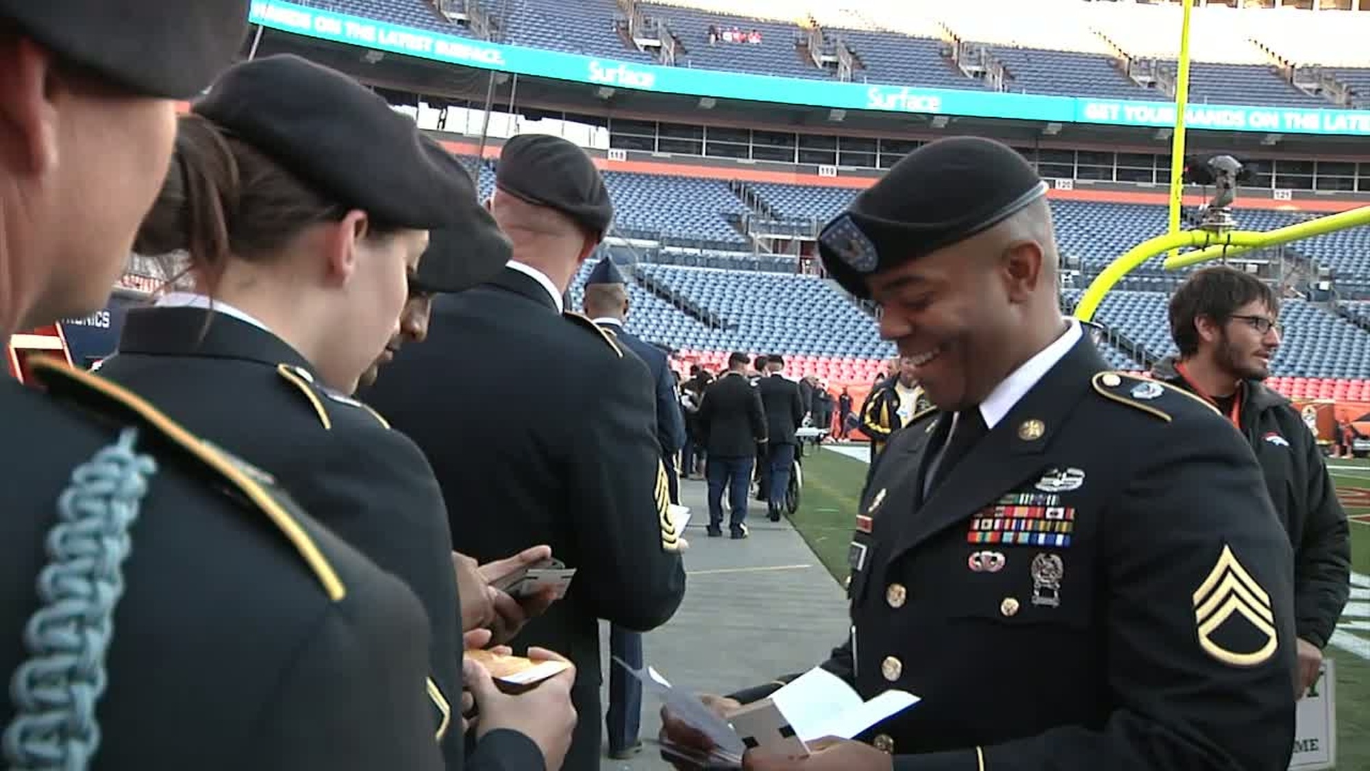 Soldiers from Fort Carson Colorado, present themselves for review to the football audience at Spoorts Authority Field in Denver, Colorado.  The fans cheer and greet the Soldiers during the Denver Broncos and Kansas City Chiefs game. Available in High Definition.
