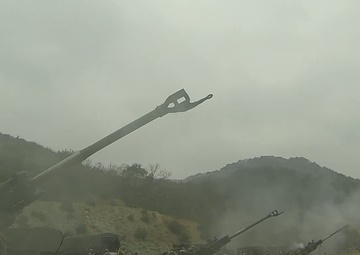 Artillery gun line firing for effect at SSang Yong 2014