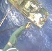 Helicopter Crew Lowers Rescue Swimmer, Pump to Save Sinking Boat