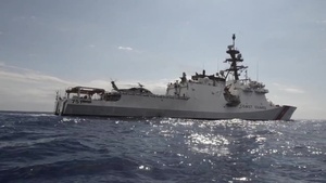 U.S. Coast Guard Cutter Waesche conducts a parts transfer with Navy helicopter