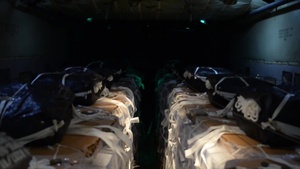 C-130 being loaded with pallets of water