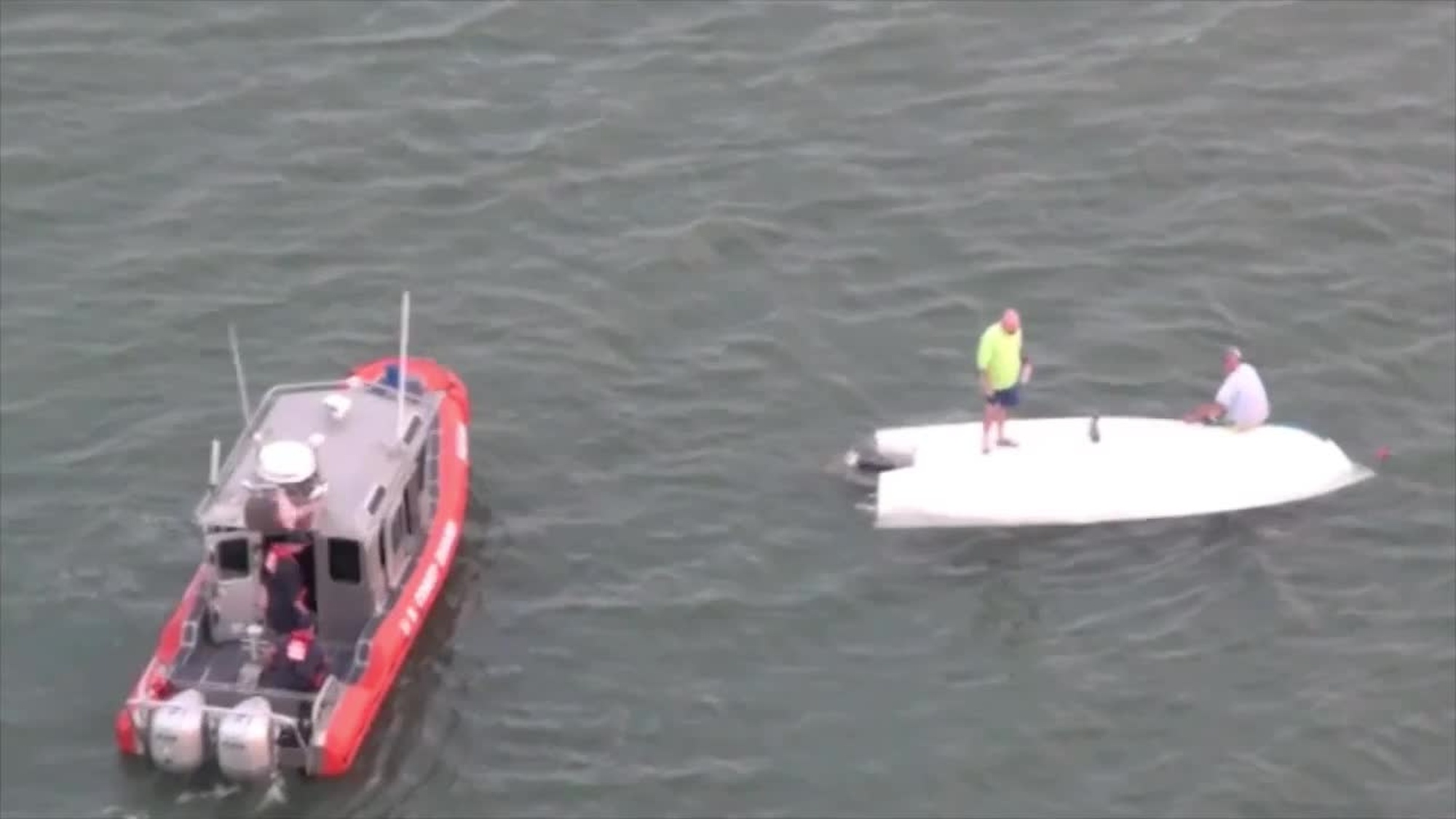 A Station Port Aransas boatcrew comes alongside an overturned boat after it capsized with five people aboard near the Aransas Pass bridge Saturday, Oct. 4, 2014. All the people were recovered with the assistance of good Samaritans and the boat was recovered by TowBoat U.S. U.S. Coast Guard video by Air Station Corpus Christi