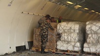 U.S. Airmen and Nepalese Soldiers Unload Aid for Nepal - (with titles)