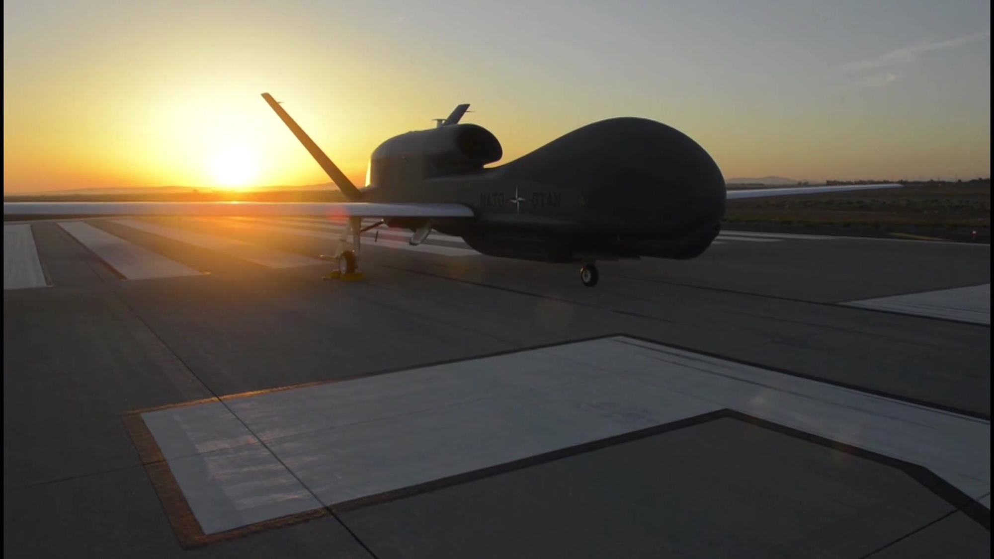 The first of NATO’s five unmanned air vehicles rolled off the factory line in San Diego on Thursday, 4 June 2015.  The Global Hawk Block 40 is part of the Alliance Ground Surveillance Program (AGS).  The NATO-owned and -operated AGS core capability will enable the Alliance to perform persistent surveillance over wide areas from high-altitude long-endurance  aircraft  in any weather or light condition . The system will give commanders a comprehensive picture of the situation on the ground.
The AGS system is being acquired by 15 Allies (Bulgaria, Czech Republic, Denmark, Estonia, Germany, Italy, Latvia, Lithuania, Luxembourg, Norway, Poland, Romania, Slovakia, Slovenia and the United States). AGS is scheduled to reach initial operational capability by the end of 2017. The air vehicles will be controlled from the main operating centre in Sigonella, Italy.