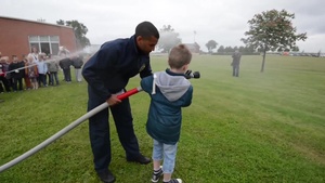 Belgian Childs Hold Fire Hoses: USAG Benelux Safety Day