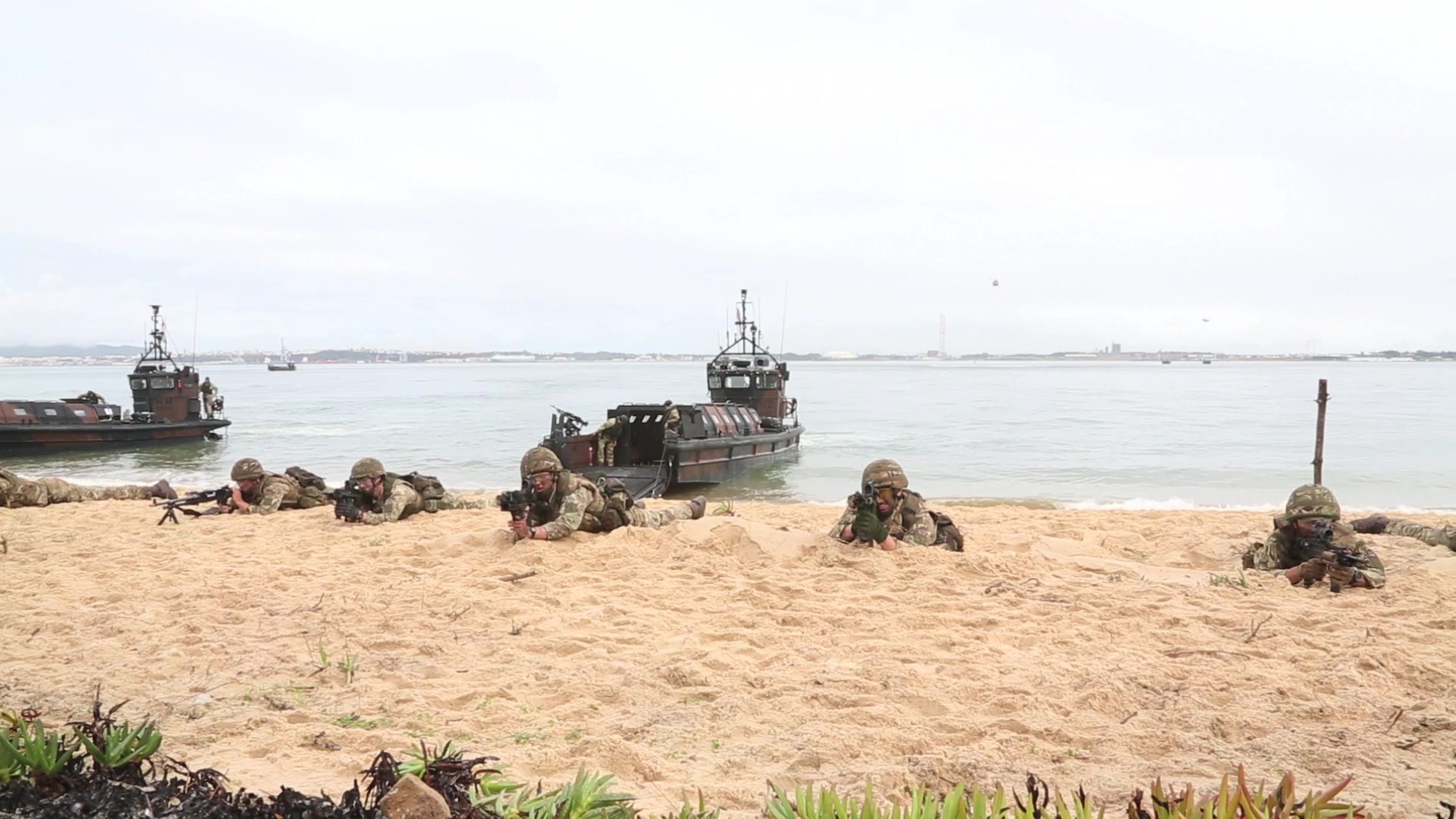 Portuguese and British Marines perform a beach landing alongside other NATO nations at a Portuguese military base in Troia, Portugal during rehearsals for a media demonstration day.<br /><br />Journalist:	Laurence Cameron<br /><br />Restrictions:<br />This media asset is free for editorial broadcast, print, online and radio use. It is restricted for use for other purposes.<br /><br />SHOTLIST:<br />00:00:00:00<br />VS PORTUGUESE BOARDING PARTY RAPPELS FROM HELICOPTER ONTO DECK OF CIVILIAN SHIP.<br /><br />00:00:15:09<br />WS ROYAL MARINE COMMANDOS IN SMALL RIB LAND ON BEACH<br /><br />00:00:28:14<br />MS ROYAL MARINE LANDING CRAFT HEADS TOWARDS BEACH<br /><br />00:00:32:14<br />VS ROYAL MARINE LANDING CRAFT DISEMBARK ROYAL MARINE COMMANDOS ONTO BEACH<br /><br />00:01:13:13<br />VS PORTUGUESE MARINES DISEMBARK FROM LANDING CRAFT ONTO BEACH.