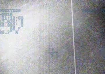 Helicopter crew hoists a man from a grounded skiff