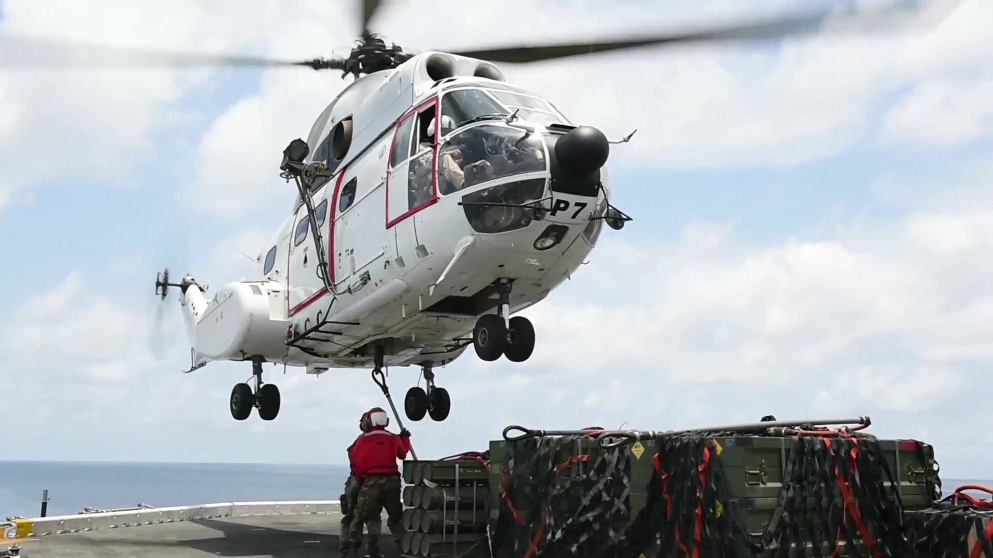 160429-N-KR961-001 GULF OF ADEN (April 29, 2016) Aviation Ordnanceman 2nd Class Patrick Keller spots Aviation Ordnanceman Airman Brandon Seay as he hooks a pallet of ordnance to an SA330-J Puma helicopter on the flight deck of amphibious assault ship USS Boxer (LHD 4). Boxer is the flagship for the Boxer Amphibious Ready Group and, with the embarked 13th Marine Expeditionary Unit, is deployed in support of maritime security operations and theater security cooperation efforts in the U.S. 5th Fleet area of operations. (U. S. Navy video by Mass Communication Specialist 2nd Class Debra Daco/Released)