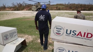 Service members with Joint Task Force Matthew deliver bags of rice, cooking oil and other supplies