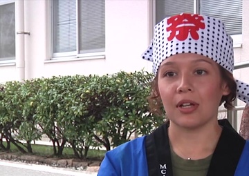 Marines and Sailors parade through the streets of Iwakuni