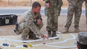 Coalition partners utilize rock drill training to defeat an IED