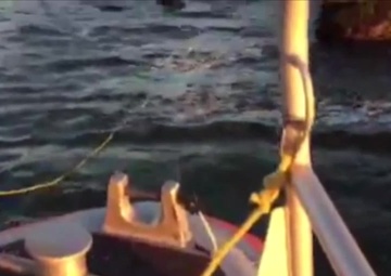 Coast Guard boat crew, surface swimmer rescue windsurfer from rocks near Point Judith, RI
