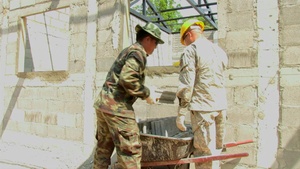 Members of the U.S. Army work with Royal Thai Soldiers to build multipurpose room during Cobra Gold 2017