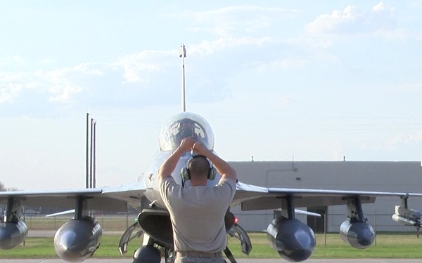 Crew Chief directs F-16 pilot into parking spot