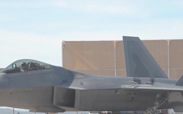 F-22 Raptors and P-51 Mustangs flying in formation